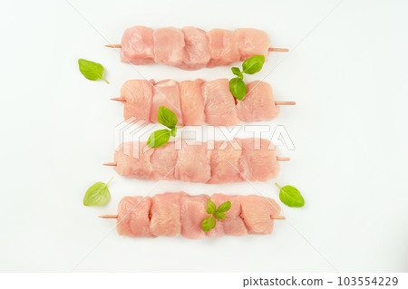 Raw chicken.Skewers from raw chicken meat fillet for supermarket on white background.Food for retail.Chicken skewers.Chicken breast Fillets Procurement for designers.Ogranic food,healthy eating. Raw chicken.Skewers from raw chicken meat fillet for supermarket on white background.Food for retail.Chicken skewers.Chicken breast Fillets Procurement for designers.Ogranic food,healthy eating. 103554229