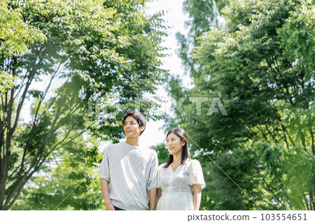 Male and female couple walking in the park Male and female couple walking in the park 103554651
