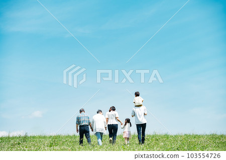 A family of three generations walking on the bank 103554726