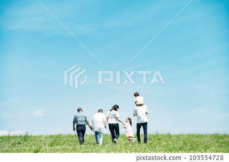 A family of three generations walking on the bank A family of three generations walking on the bank 103554728
