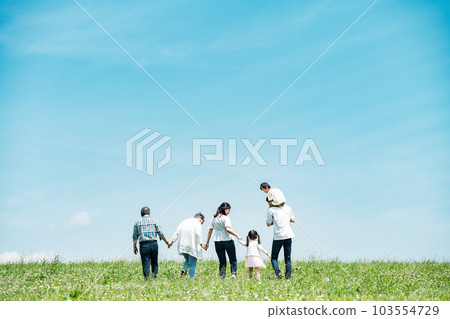 A family of three generations walking on the bank A family of three generations walking on the bank 103554729