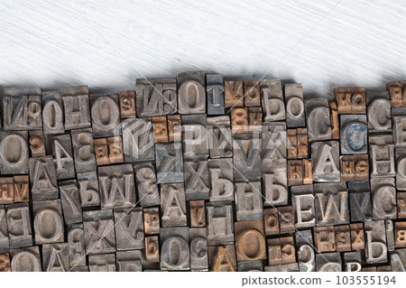 Antique vintage movable type alphabet set on white wooden deck Antique vintage movable type alphabet set on white wooden deck 103555194