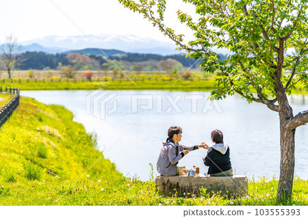 A couple taking a coffee break Park Lake A couple taking a coffee break Park Lake 103555393