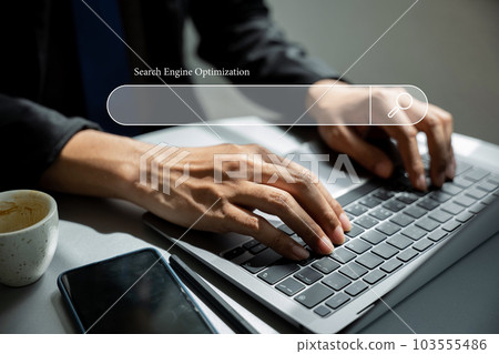 Using a blank search bar, a businessman is browsing the internet and searching for information on his laptop. This stock photo portrays the concept of search engine optimization and networking. 103555486
