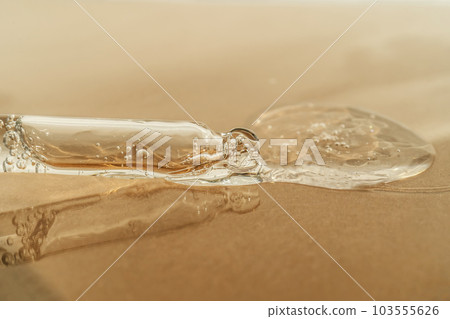 The texture of serum or oil with a pipette on a beige background. 103555626