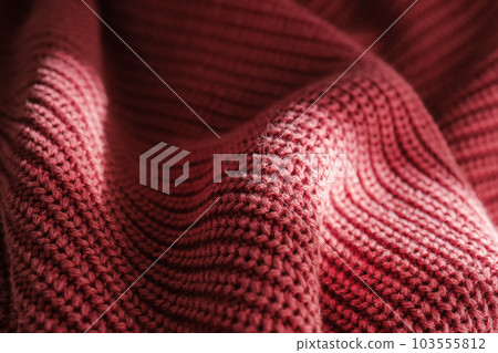 Knitted texture of a pink sweater or scarf close-up. Knitted texture of a pink sweater or scarf close-up. 103555812