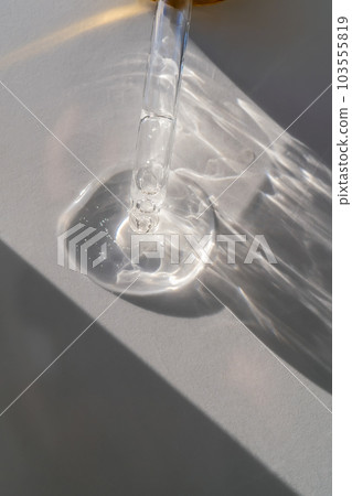 The texture of the serum or oil on an emerald background. 103555819