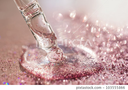 The texture of the serum or oil on an emerald background. 103555866