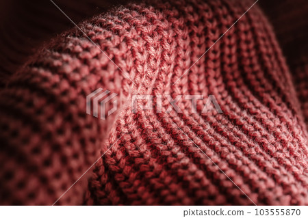 Knitted texture of a pink sweater or scarf close-up. Knitted texture of a pink sweater or scarf close-up. 103555870
