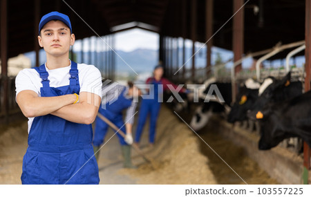 Portrait of young male farmer looking at camera during work on farm Portrait of young male farmer looking at camera during work on farm 103557225
