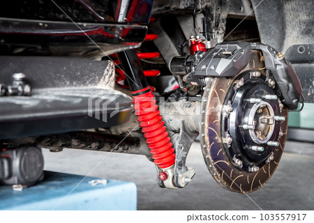 Checking car brake system for repair at car garage 103557917