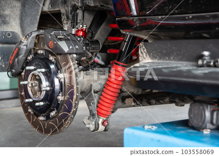 Checking car brake system for repair at car garage 103558069