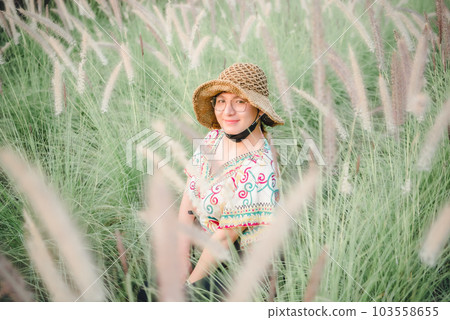 Woman (LGBTQ) posing at flower park garden field 103558655