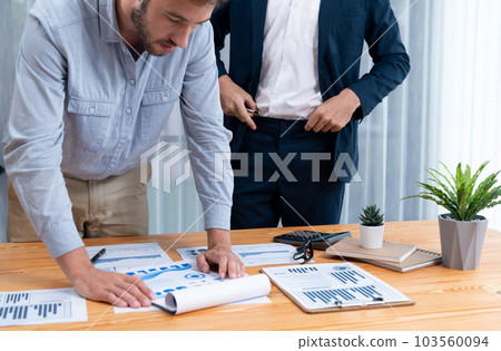 Analyst team in office analyzing financial data analysis papers. Entity Analyst team in office analyzing financial data analysis papers. Entity 103560094