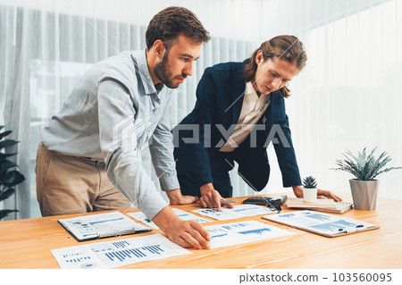 Analyst team in office analyzing financial data analysis papers. Entity 103560095