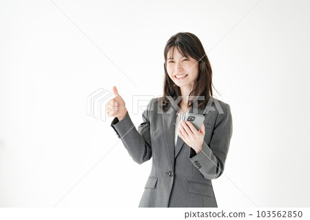 Business woman smartphone thumbs up 103562850