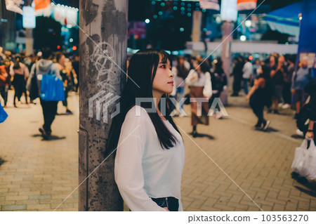 young woman standing in the city 103563270
