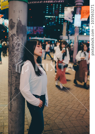 young woman standing in the city 103563271
