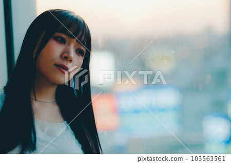 Young woman standing in the city sunset 103563561