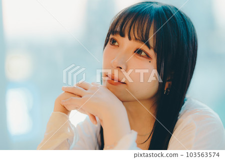 Young woman standing in the city sunset 103563574