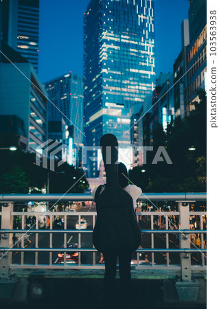young woman holding a guitar 103563938