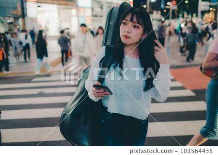 A young woman touching a smartphone A young woman touching a smartphone 103564435