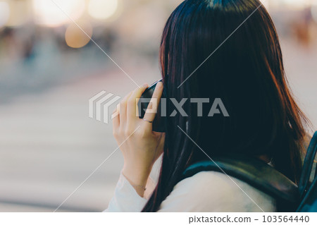 A young woman touching a smartphone A young woman touching a smartphone 103564440