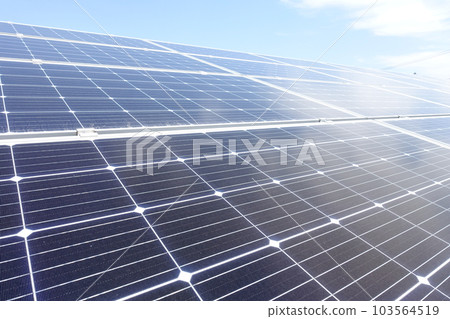 Solar panels lined up under a clear blue sky 103564519