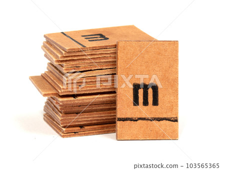 Stack of letters from a very old letterbox used to teach children - Letter m Stack of letters from a very old letterbox used to teach children - Letter m 103565365