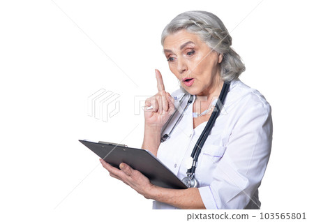 senior female doctor with folder posing on white background 103565801