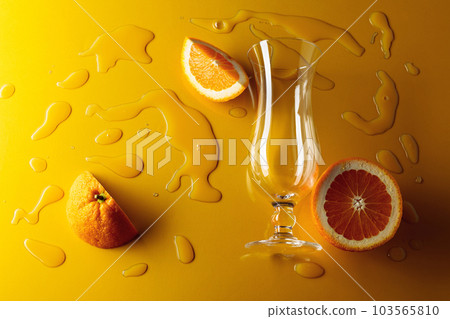 Orange juice with fruits on a yellow background. 103565810