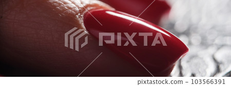 Red classic female nails on dark background 103566391