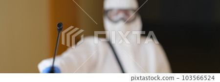 Person in protective suit spraying disinfectant closeup Person in protective suit spraying disinfectant closeup 103566524