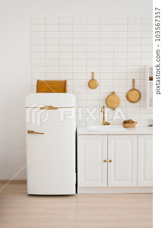 Modern new light wooden kitchen interior with white furniture and kitchen utensils Modern new light wooden kitchen interior with white furniture and kitchen utensils 103567357