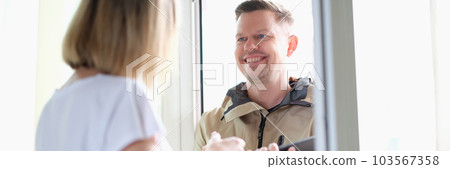 Smiling male courier or social worker with tablet conducts survey Smiling male courier or social worker with tablet conducts survey 103567358