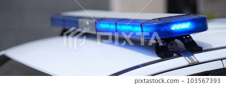 Closeup of blue lights on roof of police car 103567393