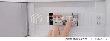 Turning on circuit breaker on control panel after it tripped due to overload 103567397