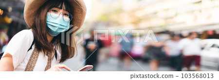 Young adult asian woman travel wear face mask for corona virus or covid 19 Young adult asian woman travel wear face mask for corona virus or covid 19 103568013