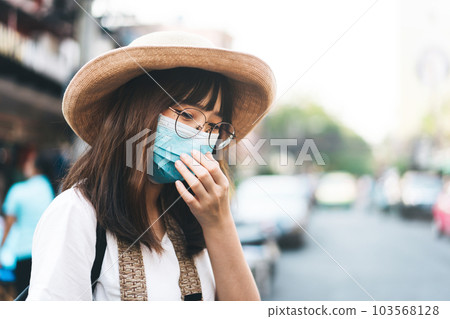 Young adult tourist asian women wear protective face mask for virus corona or covid 19 103568128