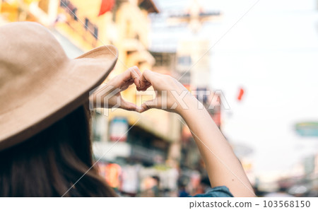 Asian traveller woman person hand with heart gesture. 103568150