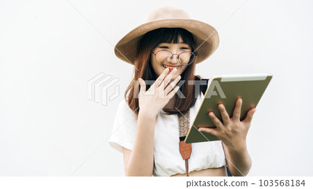 Young asian smile girl wear glasses. Travel use tablet device for smart tour. 103568184