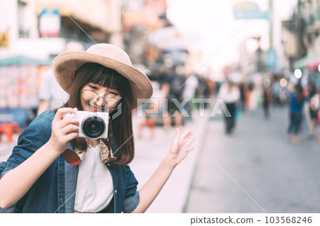 Young adult asian cute woman wear eyeglasses traveller backpack with camera solo local travel. Young adult asian cute woman wear eyeglasses traveller backpack with camera solo local travel. 103568246