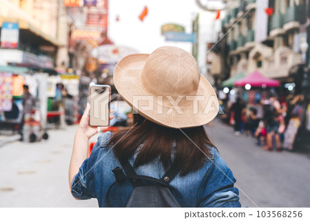 Rear view of young asian woman travel at southeast asia street market at outdoor on day 103568256