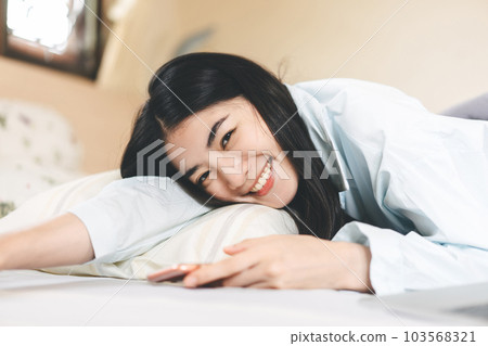 Portrait young adult asian woman relax in bedroom on morning. 103568321