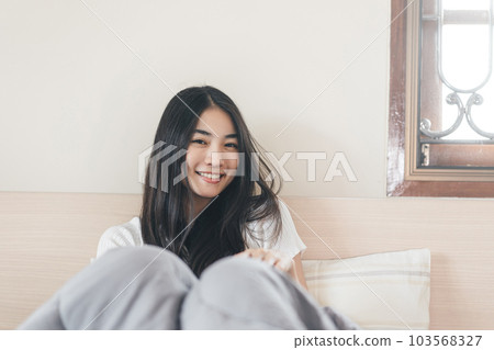 Portrait young adult asian pretty woman after wake up in morning with sunlight Portrait young adult asian pretty woman after wake up in morning with sunlight 103568327