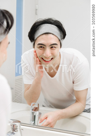 A man washing his face A man washing his face 103569980