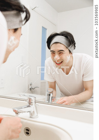 A man washing his face A man washing his face 103569985