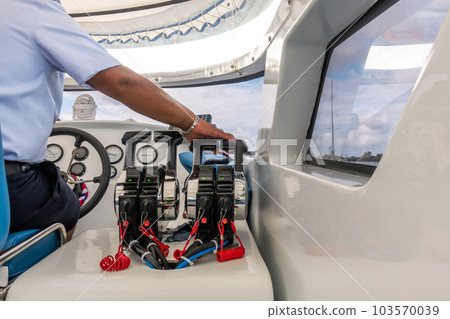Captain hand is controlling drive a speed boat 103570039