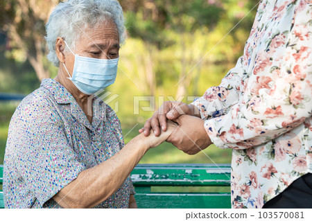 Caregiver holding hands Asian elderly woman patient with love, care, encourage and empathy at nursing hospital, healthy strong medical concept. Caregiver holding hands Asian elderly woman patient with love, care, encourage and empathy at nursing hospital, healthy strong medical concept. 103570081
