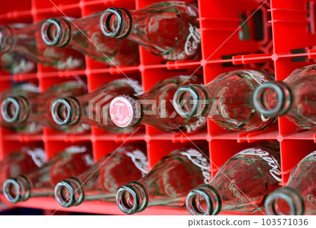 Empty cola bottles piled up at the storefront 103571036